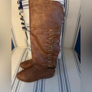Brown flat boots with buckle embellishment